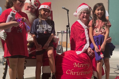 1_Festive-children-pose-with-Santa-and-Mrs.-Claus-