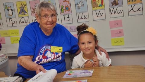 Jane Carman helps students with reading at San Carlos Park Elementary