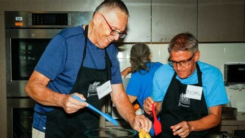 Roger Hatch and Michael Domina prepare the pineapple