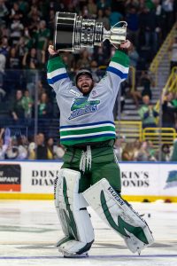 Goalie Cam Johnson hoists the Kelly Cup