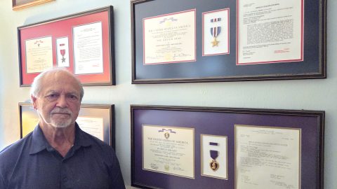 Chapin stands with his Army commendations in his study in Estero