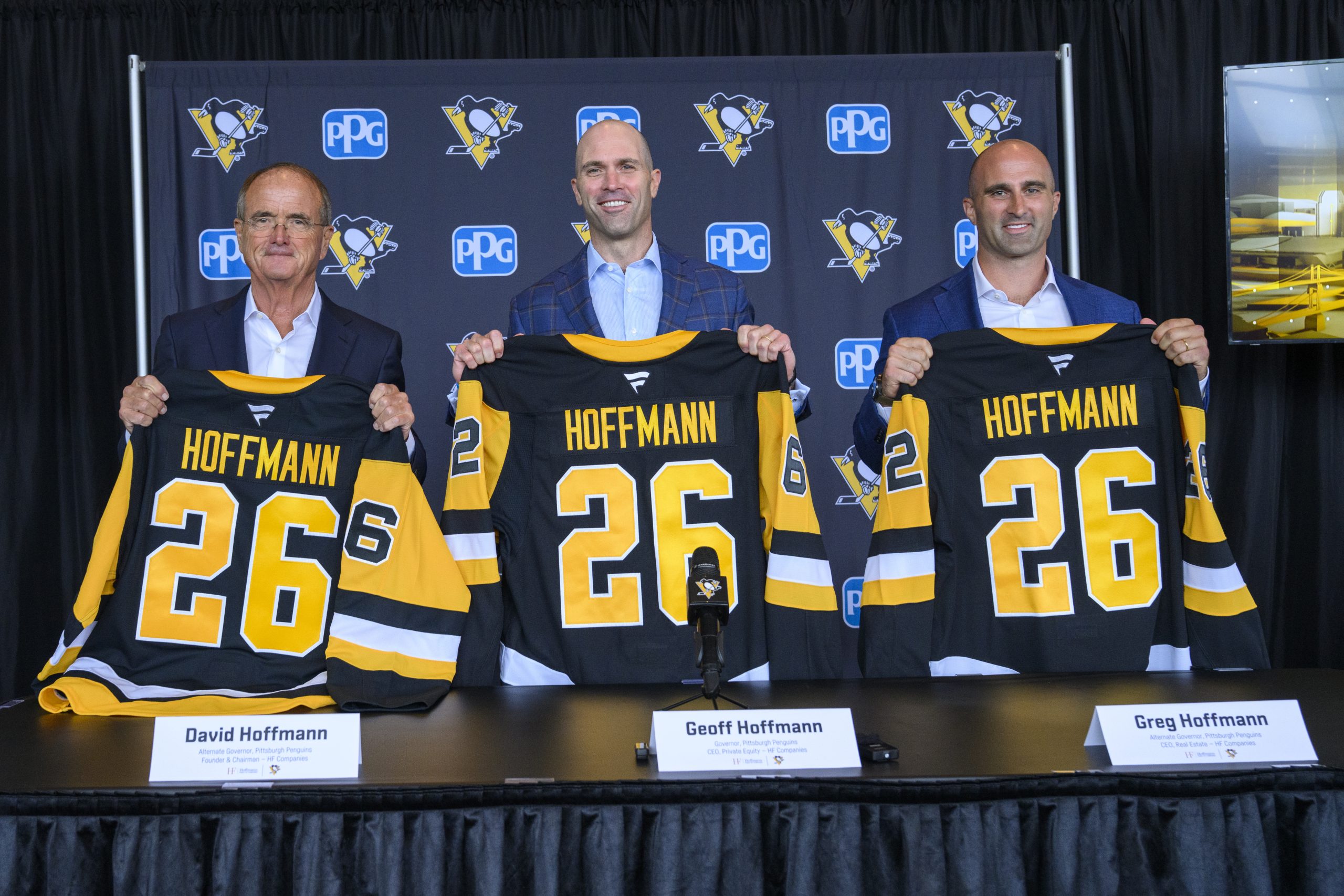 The Hoffman Family proudly holds penguins jersey's  